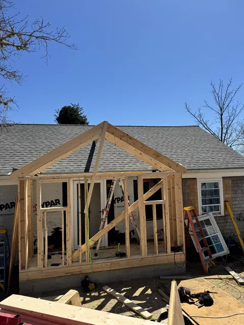Before: April 17, 2025: the new front addition framed. April 18: sheathed, wrapped and windows in.