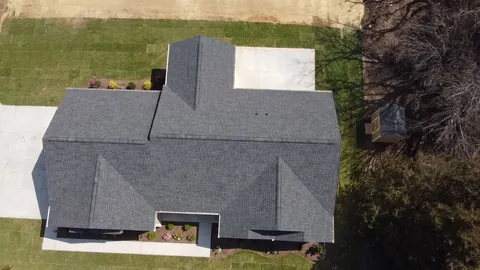 After: From straight above: our crew’s walls framed on the deck, then the same house finished under its new roof.