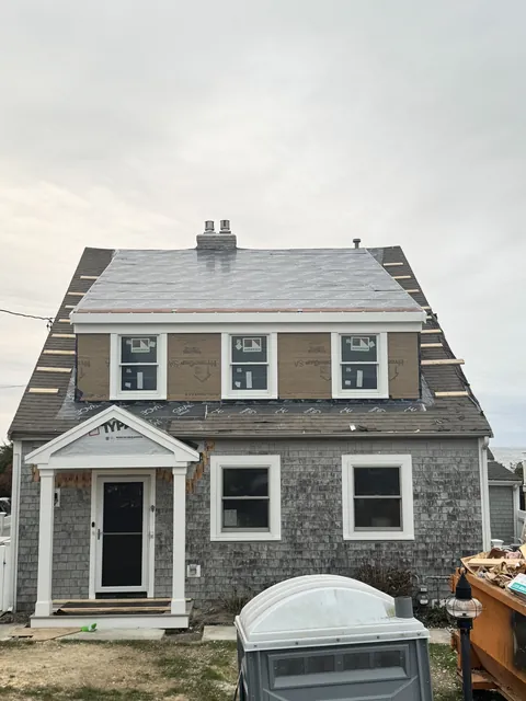 After: September 15, 2025: the old roof opened up. September 17: a full-width dormer framed and sheathed, with new windows.