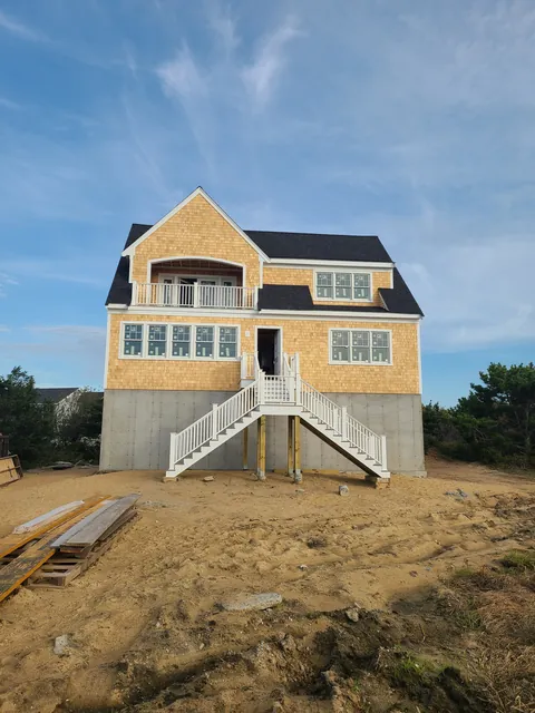 Cedar shingle beach house with an exterior stair