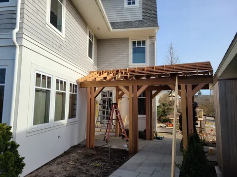 Cedar pergola over the side entry of a new home