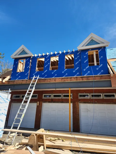 Second-floor dormer addition over a three-car garage