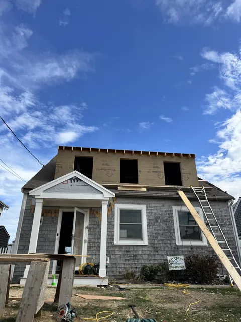Full-width dormer framed and sheathed on a shingle Cape