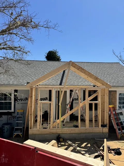 Front addition framed on a shingle Cape