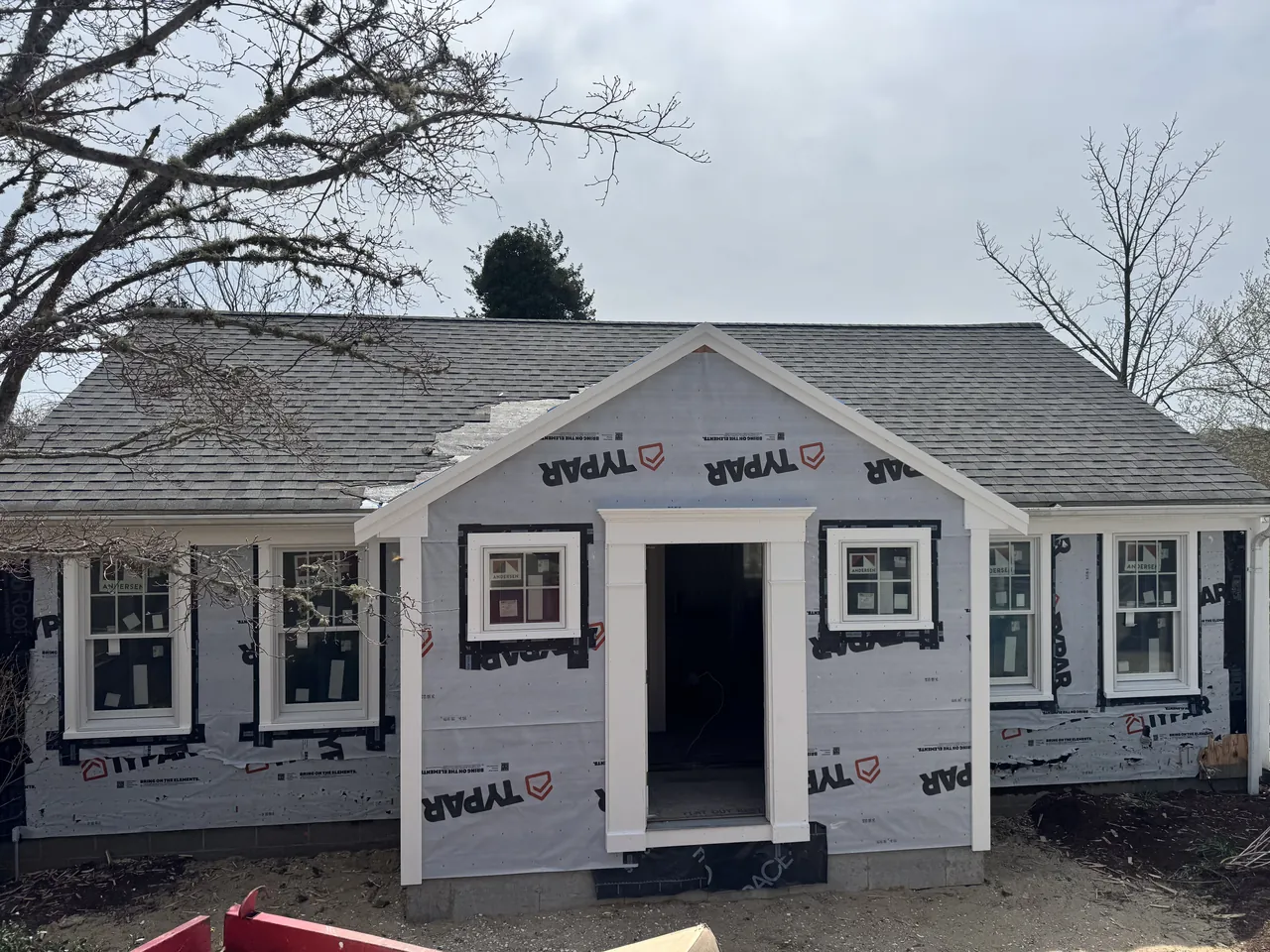 Front addition sheathed and wrapped, with new windows