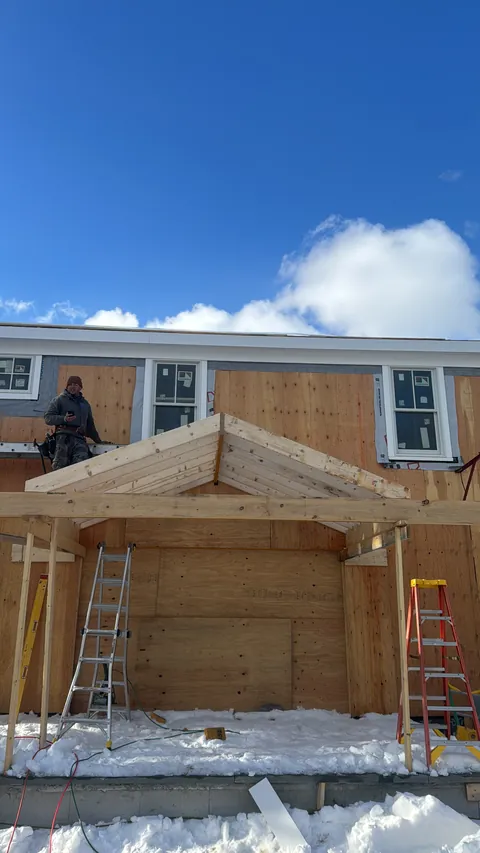 Front porch addition framed in the snow