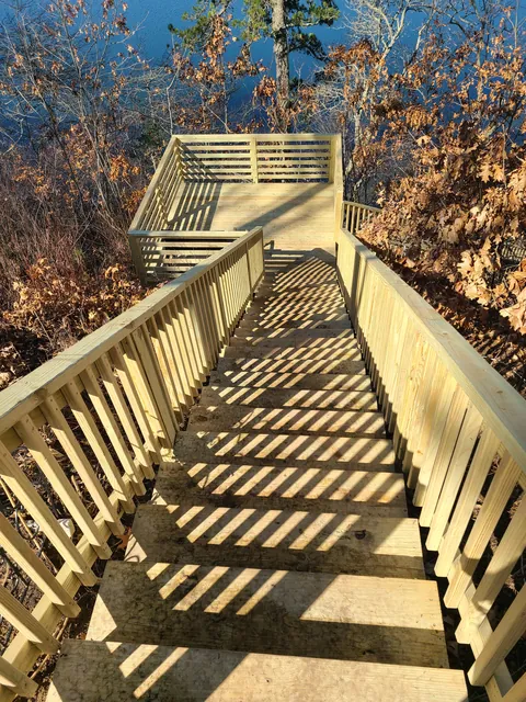 Wooden stair and landing built down a wooded bank to the water
